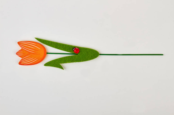 Artificial tulip with ladybird isolated. - Photo, Image