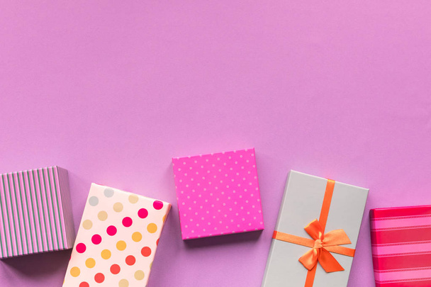 Holidays giftboxes on the pastel yellow background for birthday party - 写真・画像