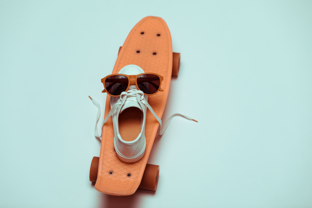 Hipster skateboard, sneaker and sunglasses - Photo, Image