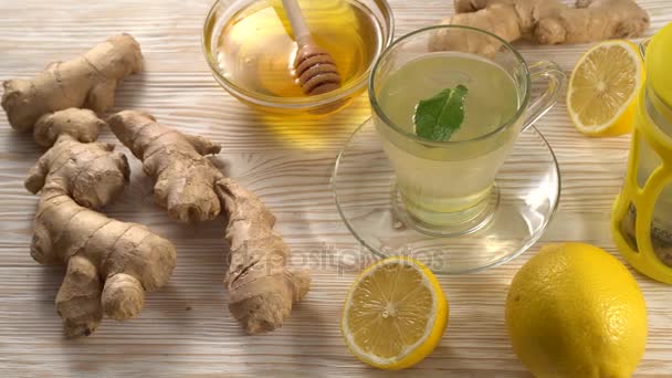Ginger tea with lemon, mint and honey on wooden background. - Footage, Video