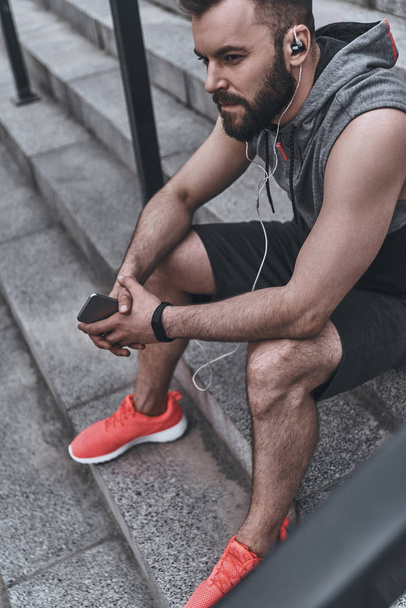 man in sport clothing listening music - Photo, image