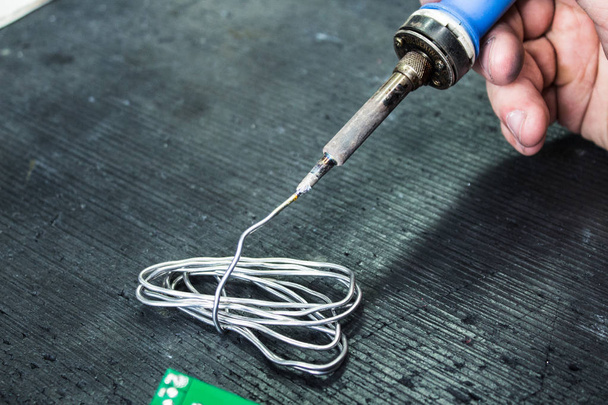 soldering iron and solder in the hands of a man - Φωτογραφία, εικόνα