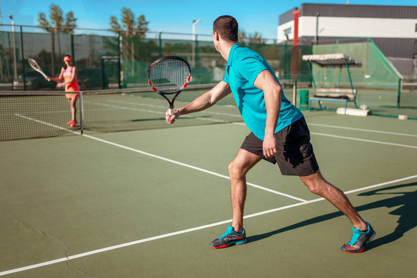 man and woman playing tennis - Photo, Image