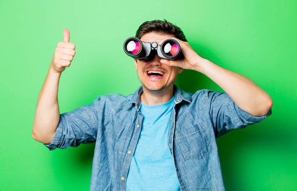 Young smiling man with binocular - Foto, Bild