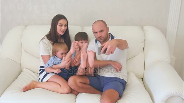 Família feliz tirando selfies engraçadas no telefone sentado no sofá
 - Filmagem, Vídeo