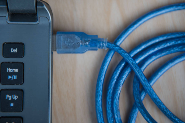closeup  USB cable connection to laptop. Technology concept - Photo, Image