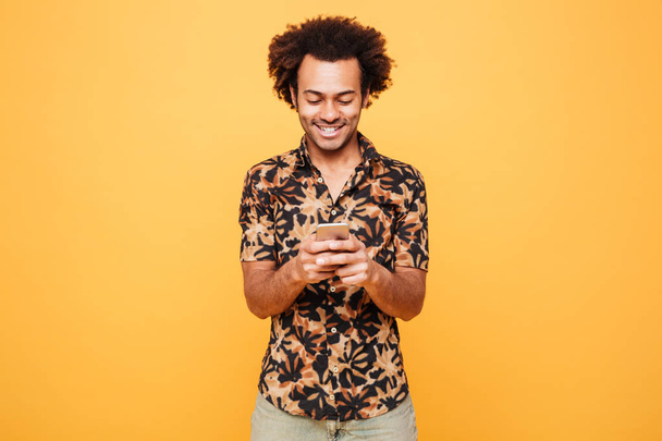 Happy young african man chatting by phone - Φωτογραφία, εικόνα