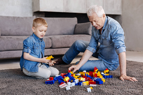 Awesome active grandpa entertaining his grandson - Photo, Image