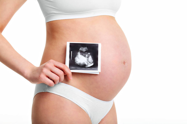 Pregnant woman holding ultrasound scan - Фото, зображення