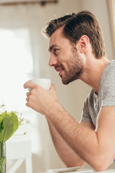 Hombre guapo bebiendo café en casa
 - Foto, Imagen