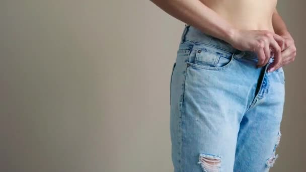 Young woman is wearing blue jeans - Footage, Video