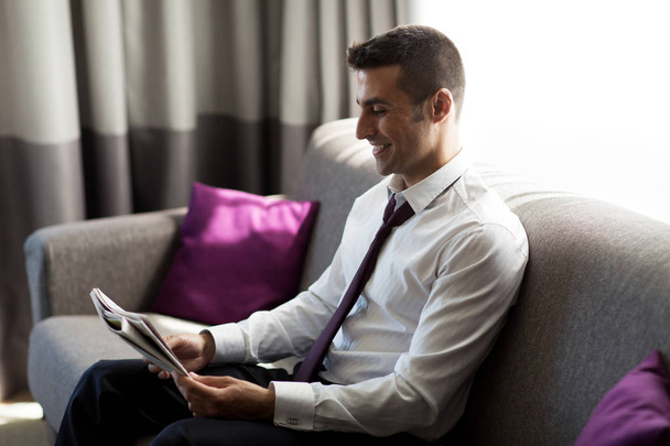 happy businessman reading newspaper at hotel room - Φωτογραφία, εικόνα