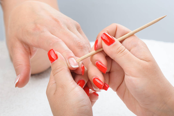 Cuticles care with cuticle pusher - Photo, Image