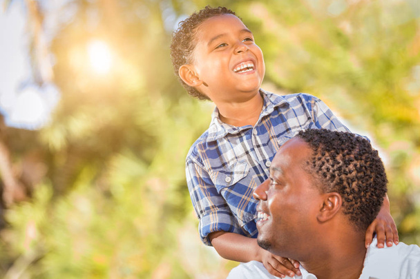 Mixed Race Son and African American Father Playing Outdoors Together. - Photo, Image