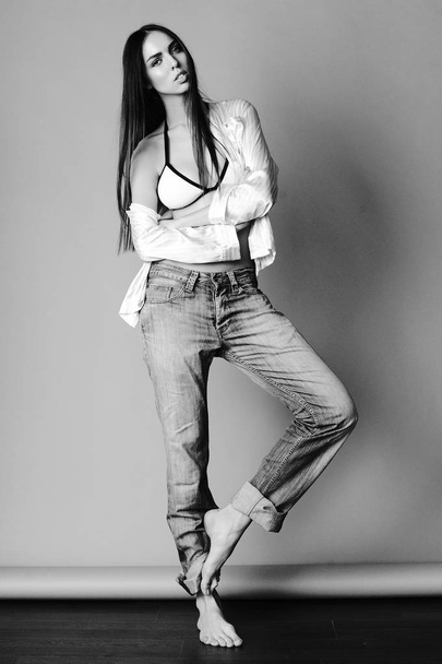 Attractive girl in  jeans, shirt and bra - Fotoğraf, Görsel
