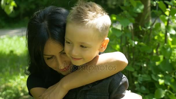 Slow motion of young mother and child hugging and showing their love - Filmmaterial, Video
