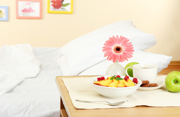 light breakfast on the nightstand next to the bed - Fotoğraf, Görsel
