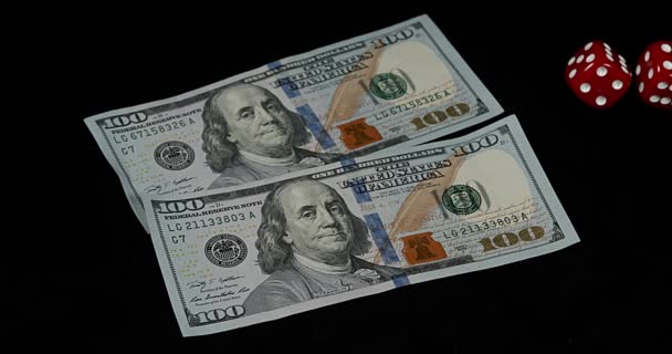 Red Dice rolling on Dollar Bills against Black Background, slow motion 4K - Video