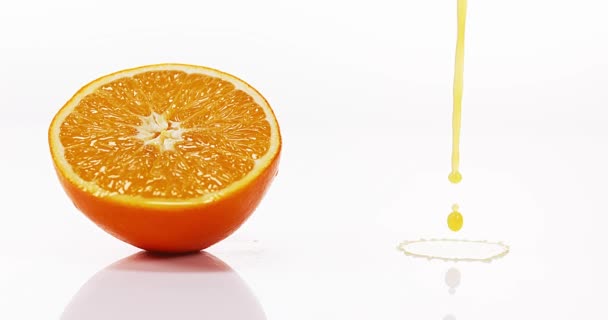 Orange Juice Flowing against White  - Materiał filmowy, wideo