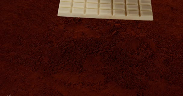 Chocolate Tablet falling on Chocolate Powder - Záběry, video