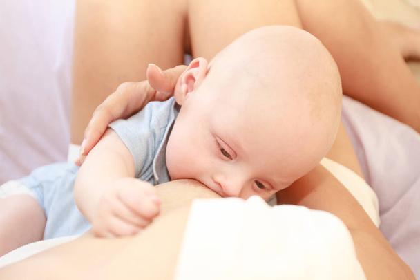 indoor portrait of mother breast feeding - Foto, Imagem