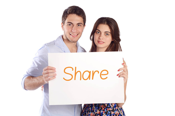 Couple holding cardboard with "share". - Fotoğraf, Görsel