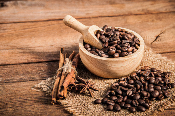 Coffee beans on wooden table. - Φωτογραφία, εικόνα
