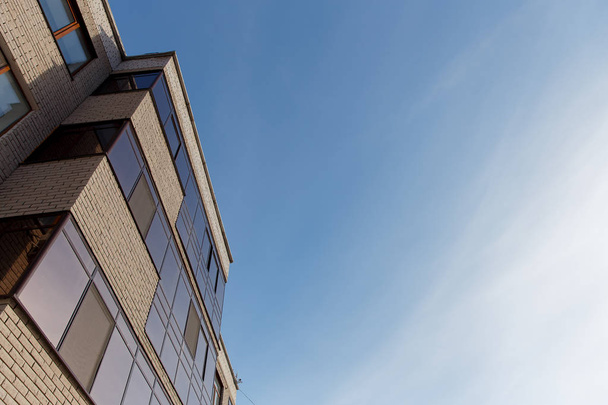 The new multi-storey residential building against blue sky. - Valokuva, kuva