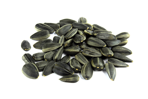 Black sunflower seeds isolated over white background - Photo, Image