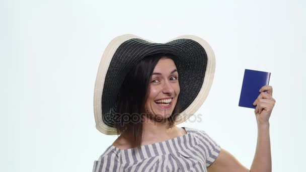 Portrait of pretty happy young woman holding passport on holiday on white background - Video, Çekim