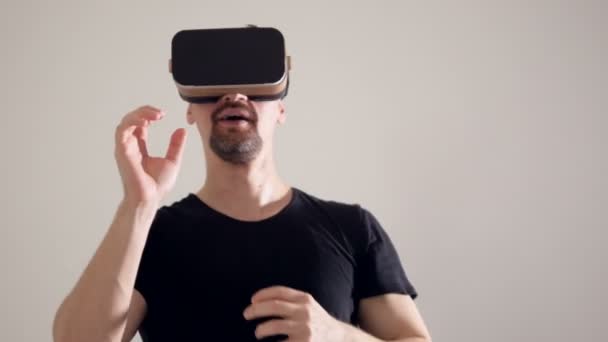 A man wearing virtual reality headset reaching out his hands. - Video, Çekim
