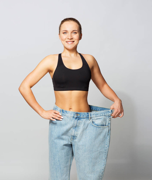 young slim sporty woman in oversize pants - Photo, image