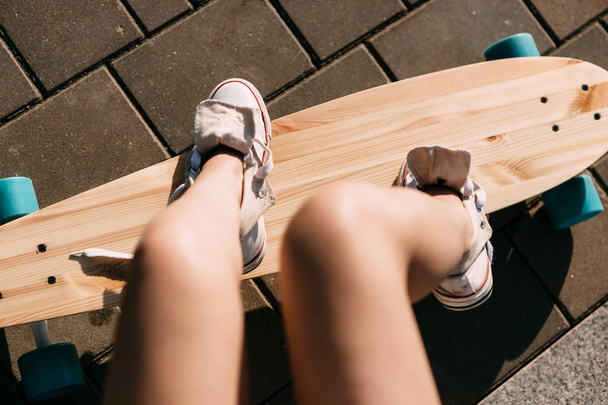 Girl with wooden longboard skateboard. - 写真・画像