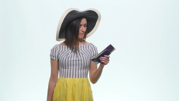 Portrait of happy tourist woman holding map on holiday on white background - Materiał filmowy, wideo