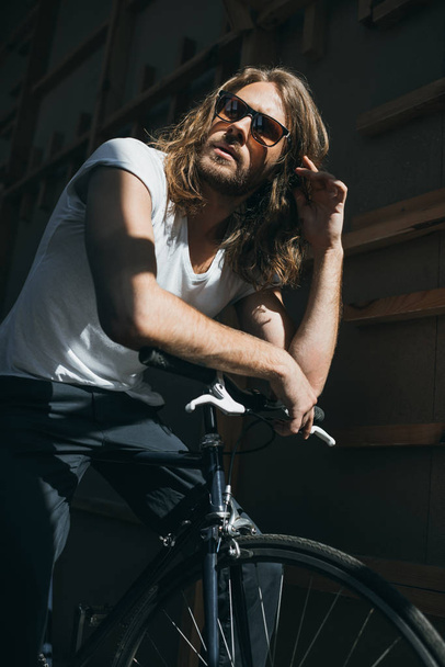 Young man with bicycle  - Фото, зображення