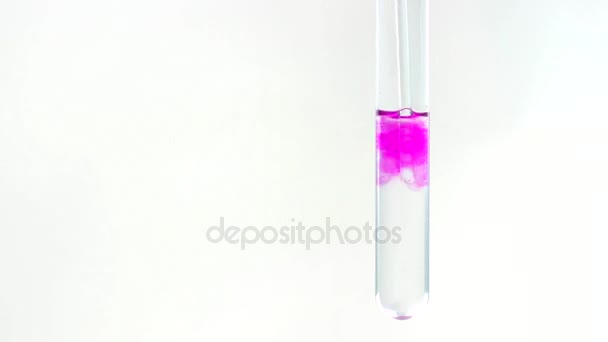 Mixing of alkali and phenolphthalein solution, chemical reaction. The test tube is close-up. - Footage, Video