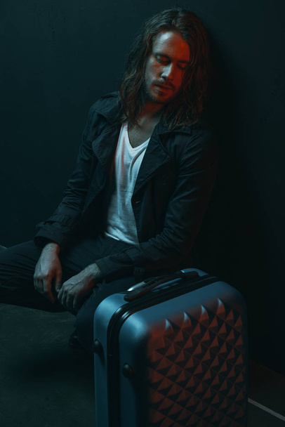 Young man with suitcase  - Valokuva, kuva
