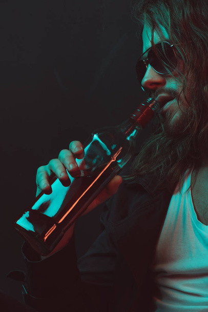 drunkard in sunglasses drinking whiskey from bottle - Fotografie, Obrázek