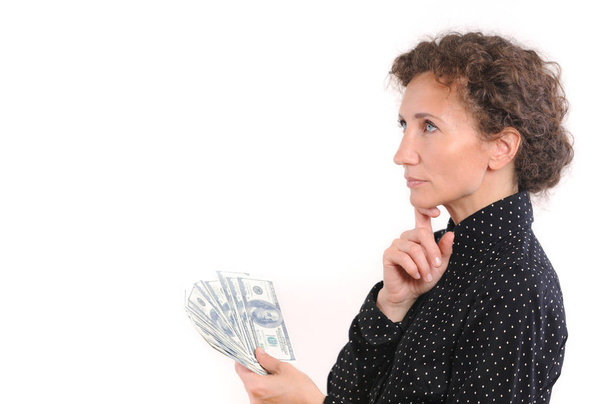 Cheerful attractive lady holding cash and happy smiling - Photo, Image