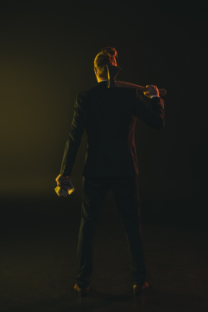 man in tuxedo holding ax and money - Zdjęcie, obraz