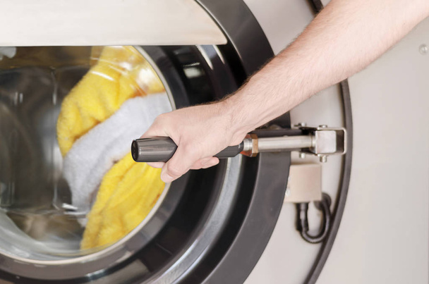 hand put laundry in the machine - Photo, image