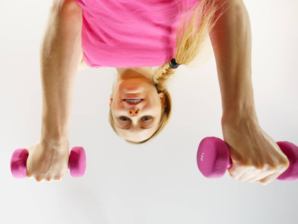 Teenage woman working out at home with dumbbell - Foto, Imagem