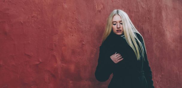 Blonde by Red wall - Photo, Image
