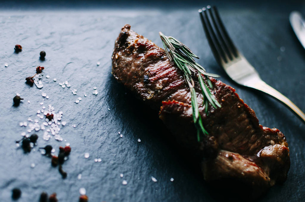 Meat steak with rosemary - Фото, изображение