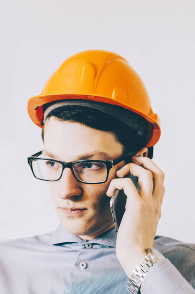 Young male engineer in hardhat - 写真・画像