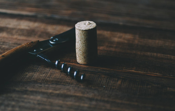 Metal corkscrew on table - Фото, изображение