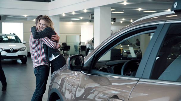Man Surprising Woman with New Car In Show Room - Photo, Image