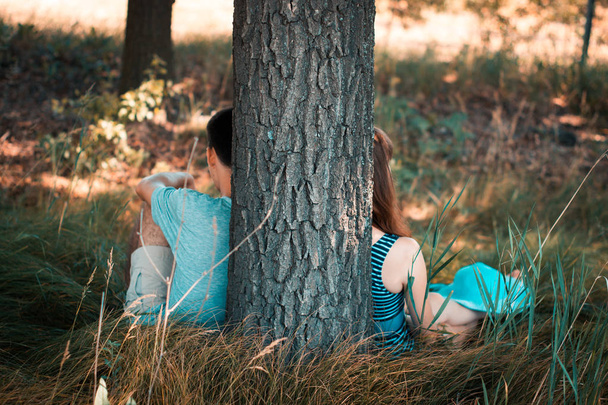 Friends guy and girl near a tree in the nature. - Photo, image