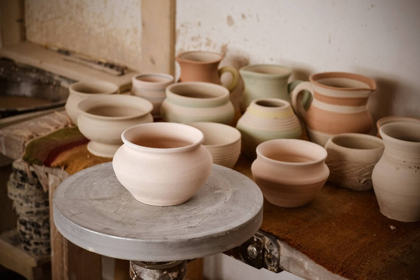 Clay pot on a potter's wheel - Photo, image