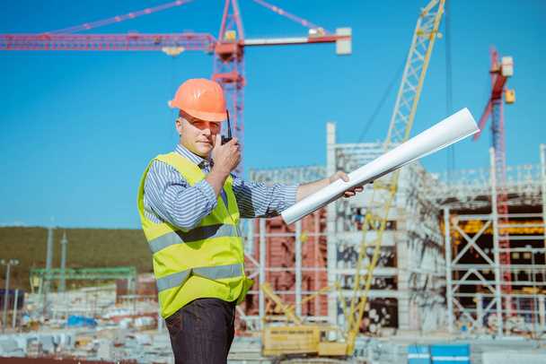 Portrait of a male engineer on a construction site background - Fotó, kép